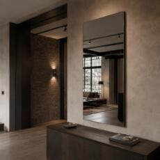 Industriële spiegel boven een donker houten dressoir in een modern loftinterieur.