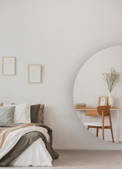 Een half ronde moderne spiegel in een slaapkamer